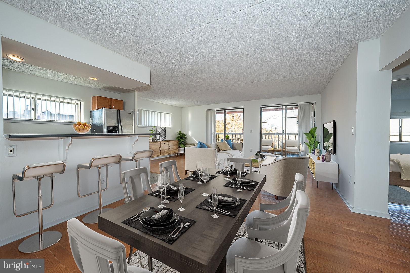 a living room with furniture a wooden floor and a window