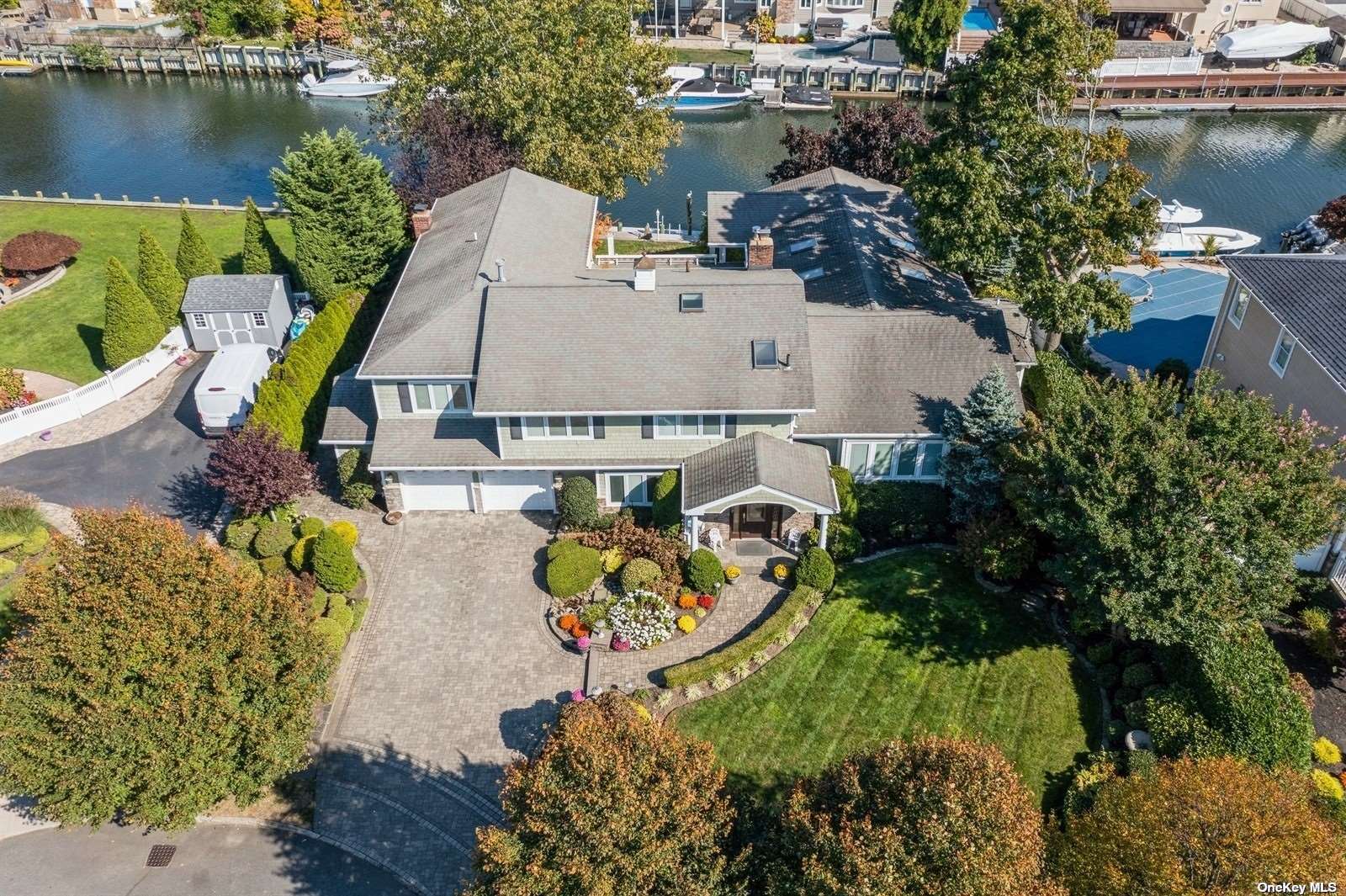 an aerial view of a house with a garden and lake view