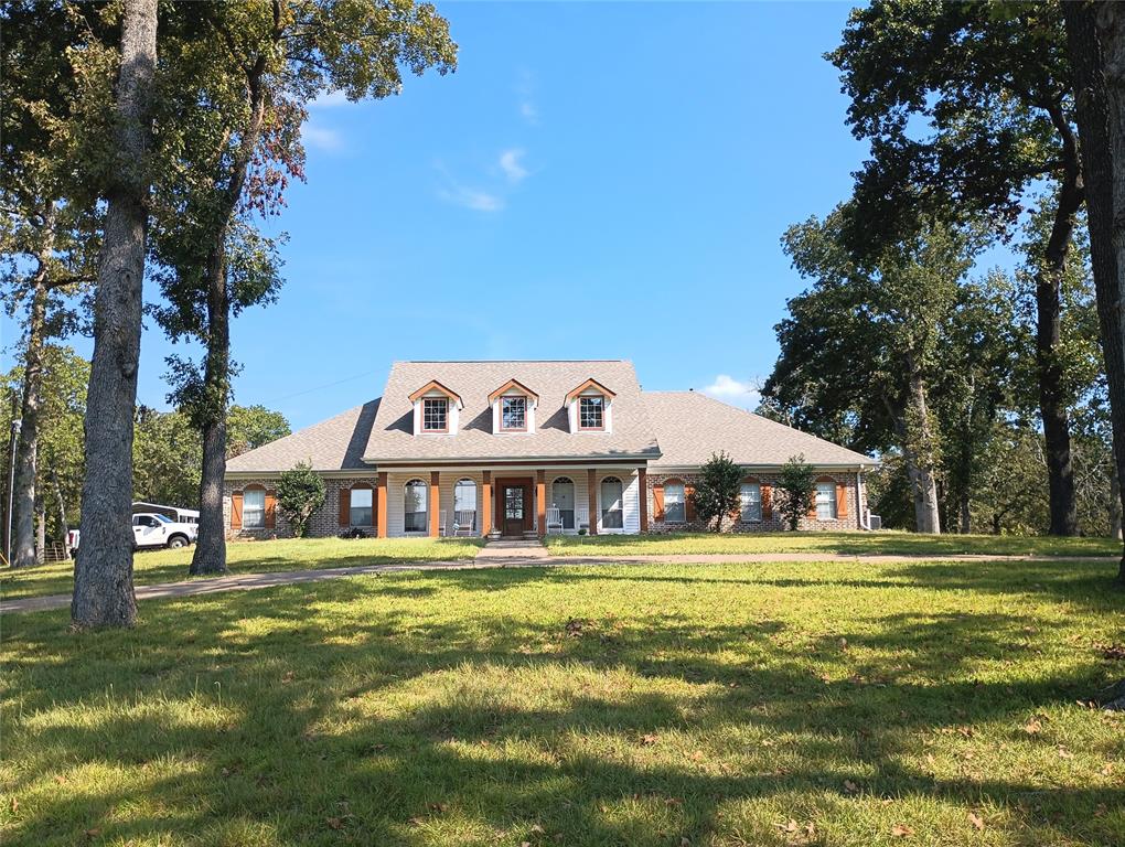 a front view of a building with trees