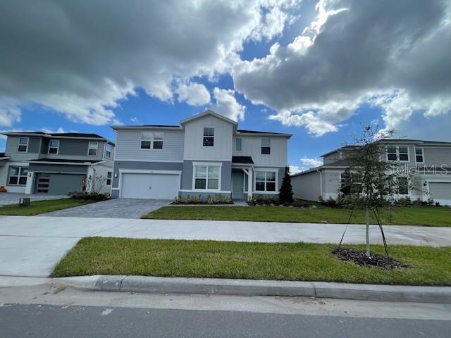 a front view of a house with a yard and garage