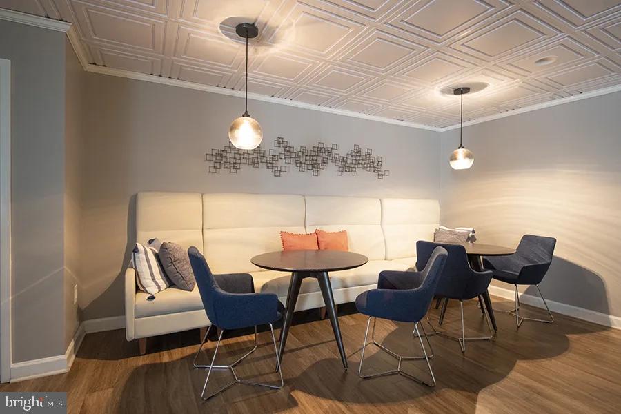 a dining room with furniture and wooden floor