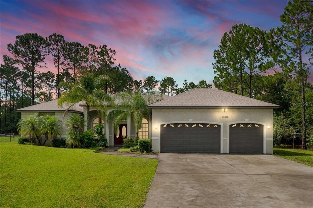 a front view of a house with a yard and garage