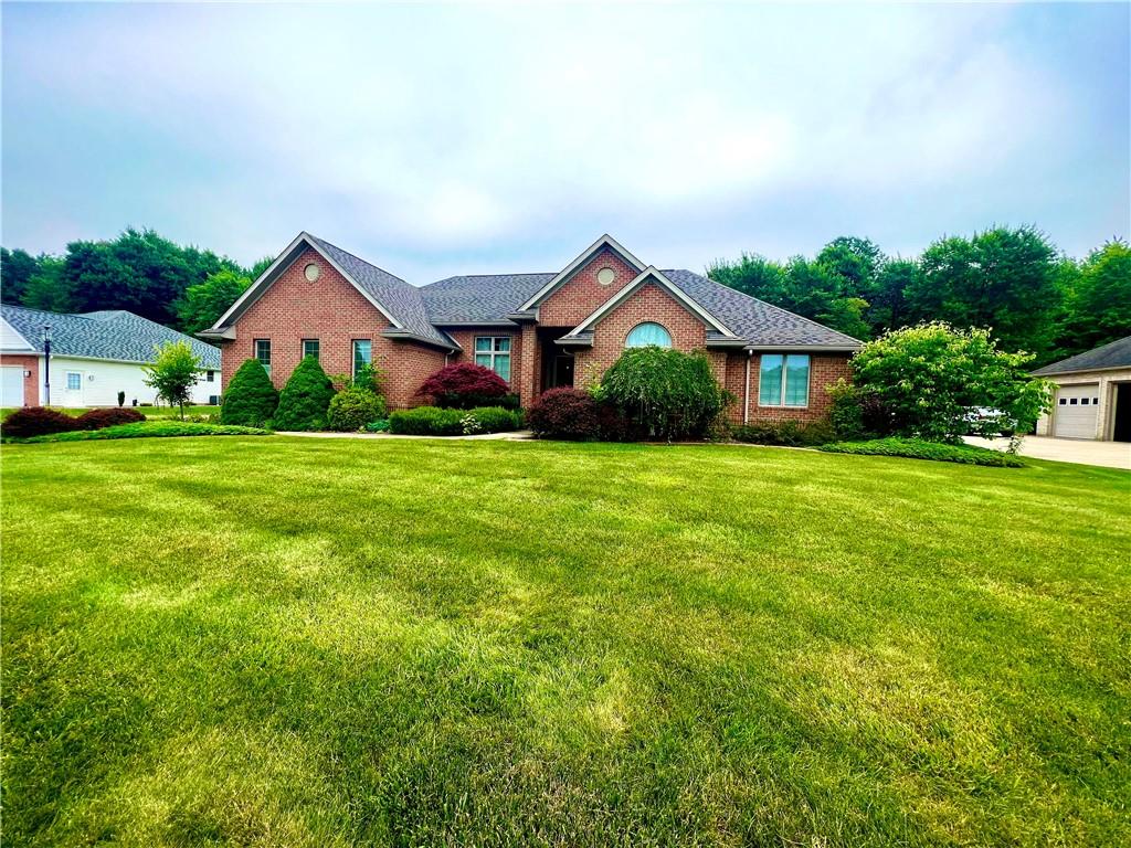 a front view of house with yard and green space