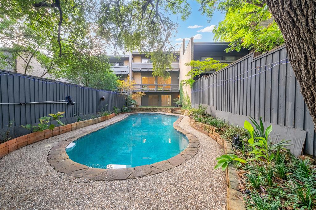 a view of a swimming pool with a backyard