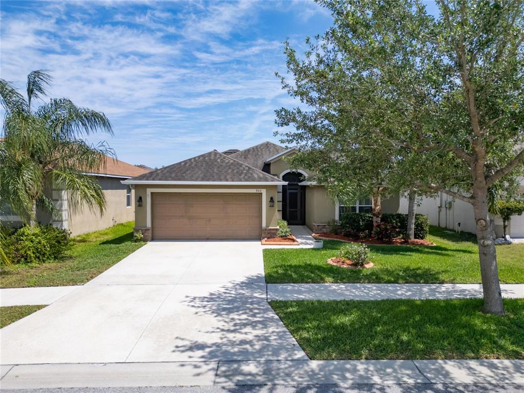 a front view of a house with a yard and garage