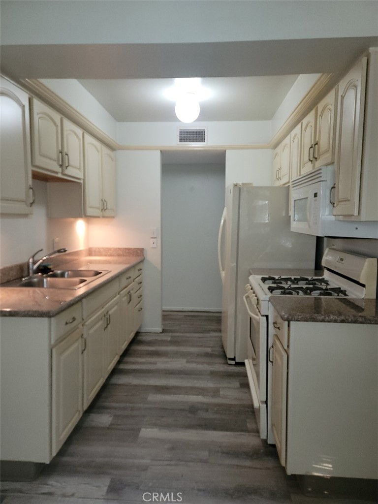 a kitchen with stainless steel appliances granite countertop a stove and a refrigerator