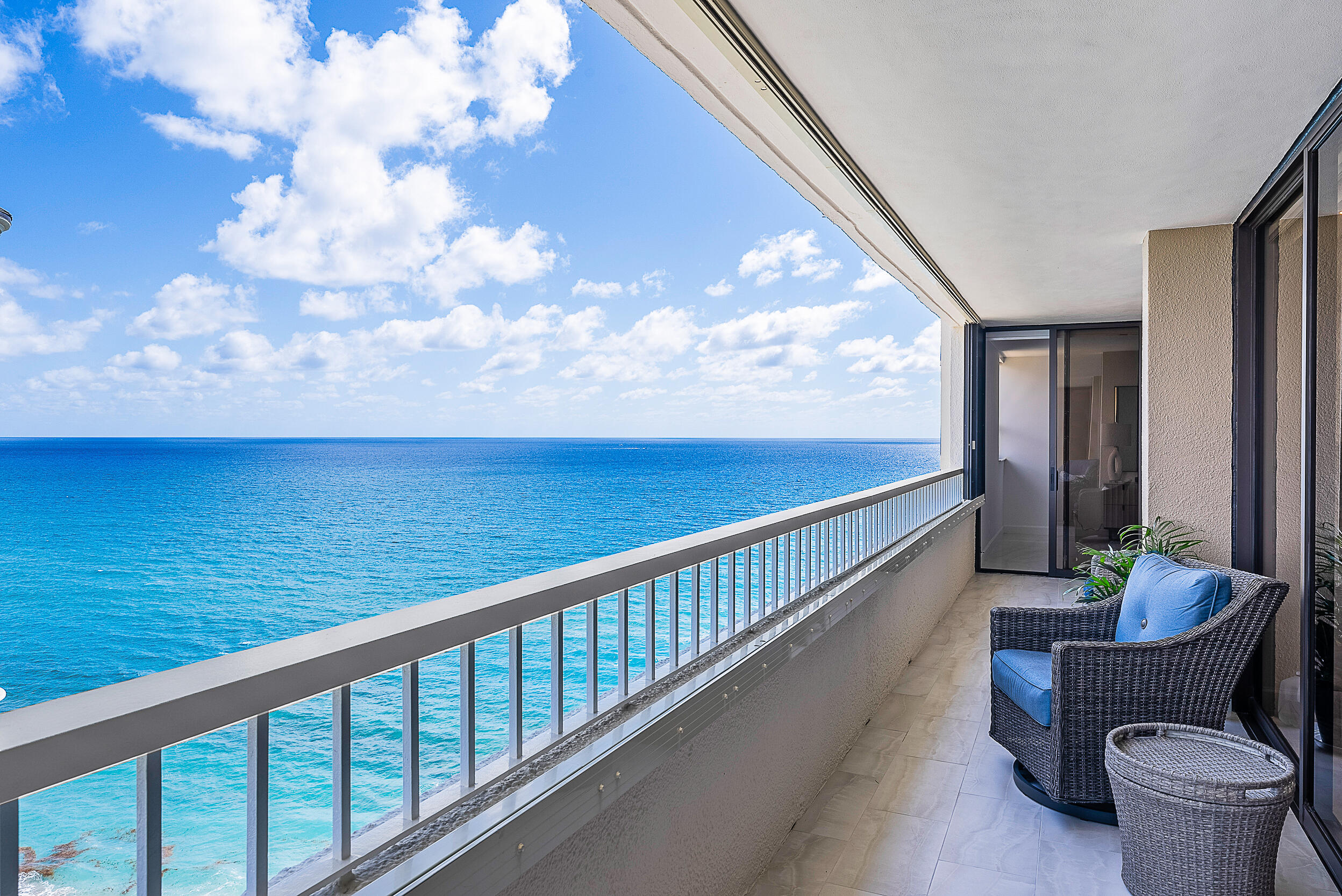 a balcony with table and chairs