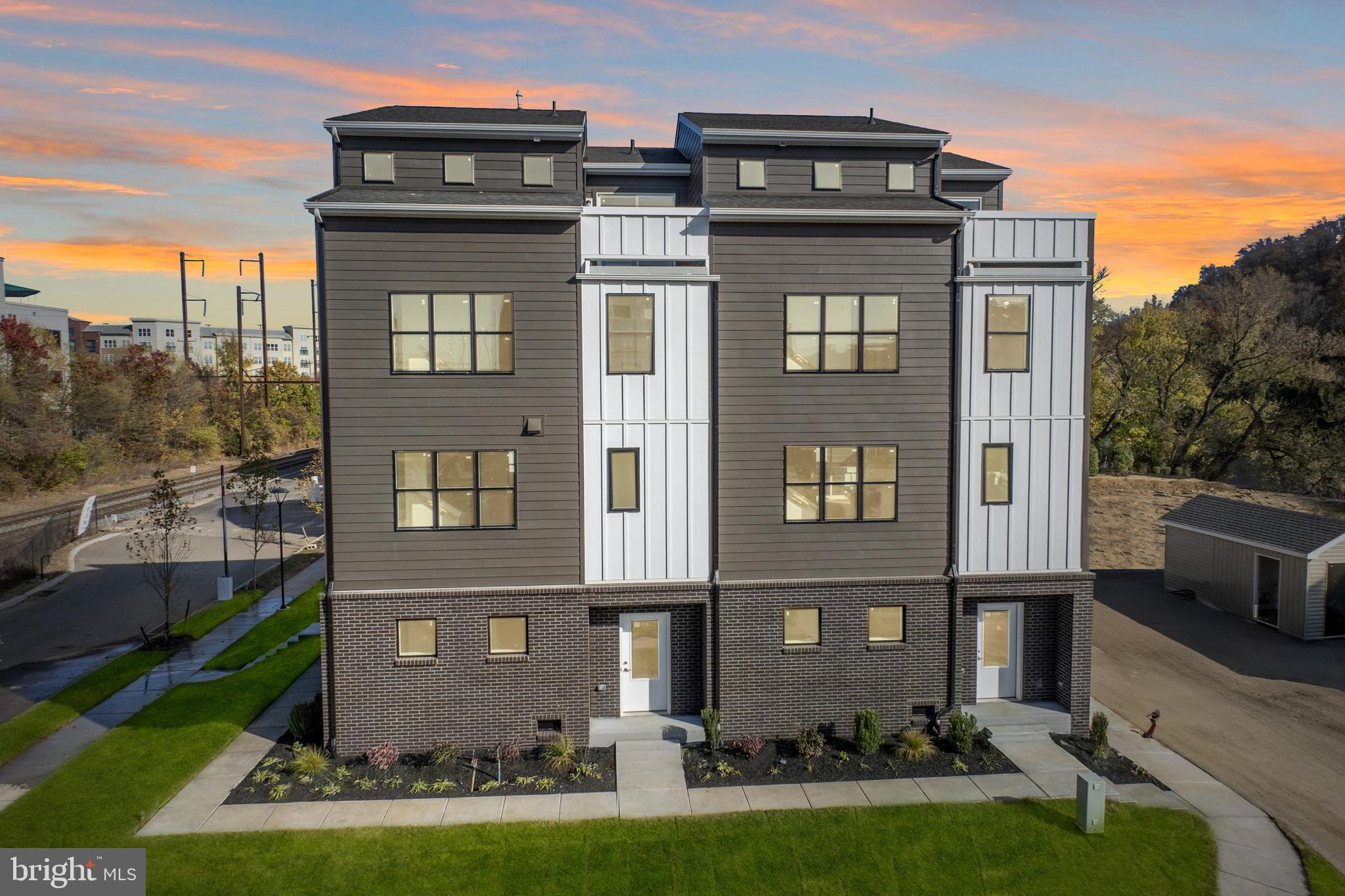 a front view of a residential apartment building with a yard