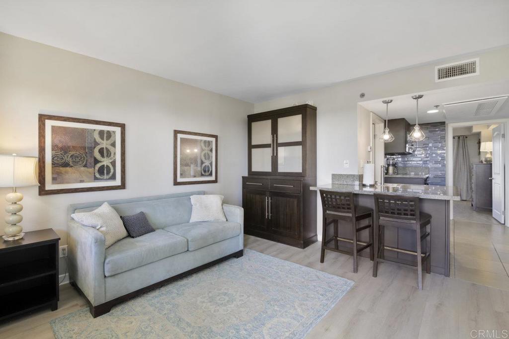 a living room with furniture a dining table and kitchen view