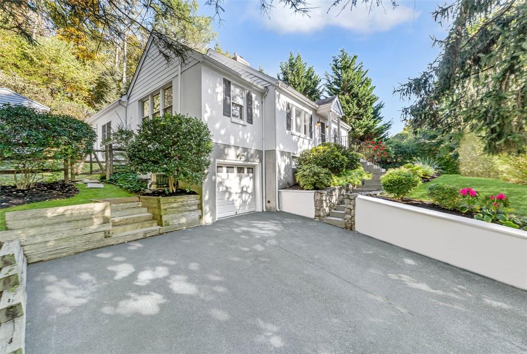 View of side of property with a garage