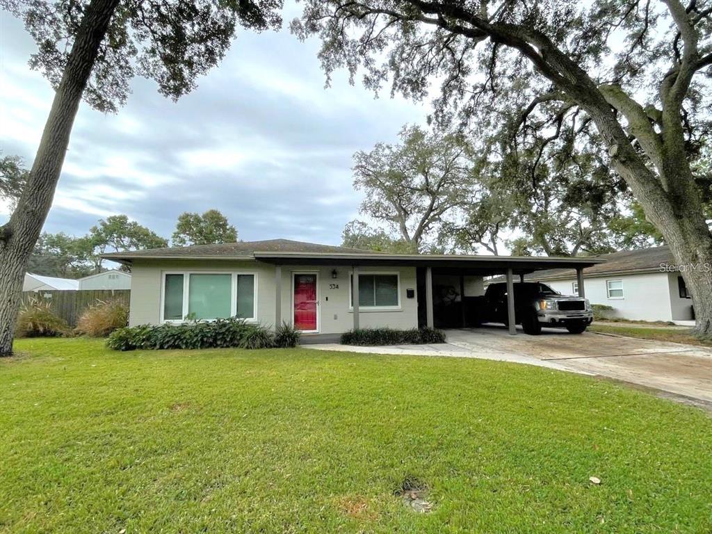 a front view of house with yard and green space