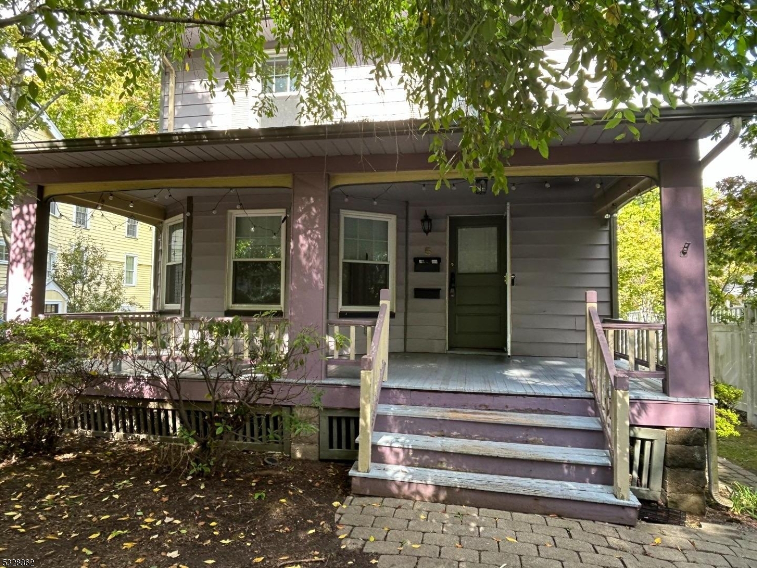 a front view of a house with outdoor seating