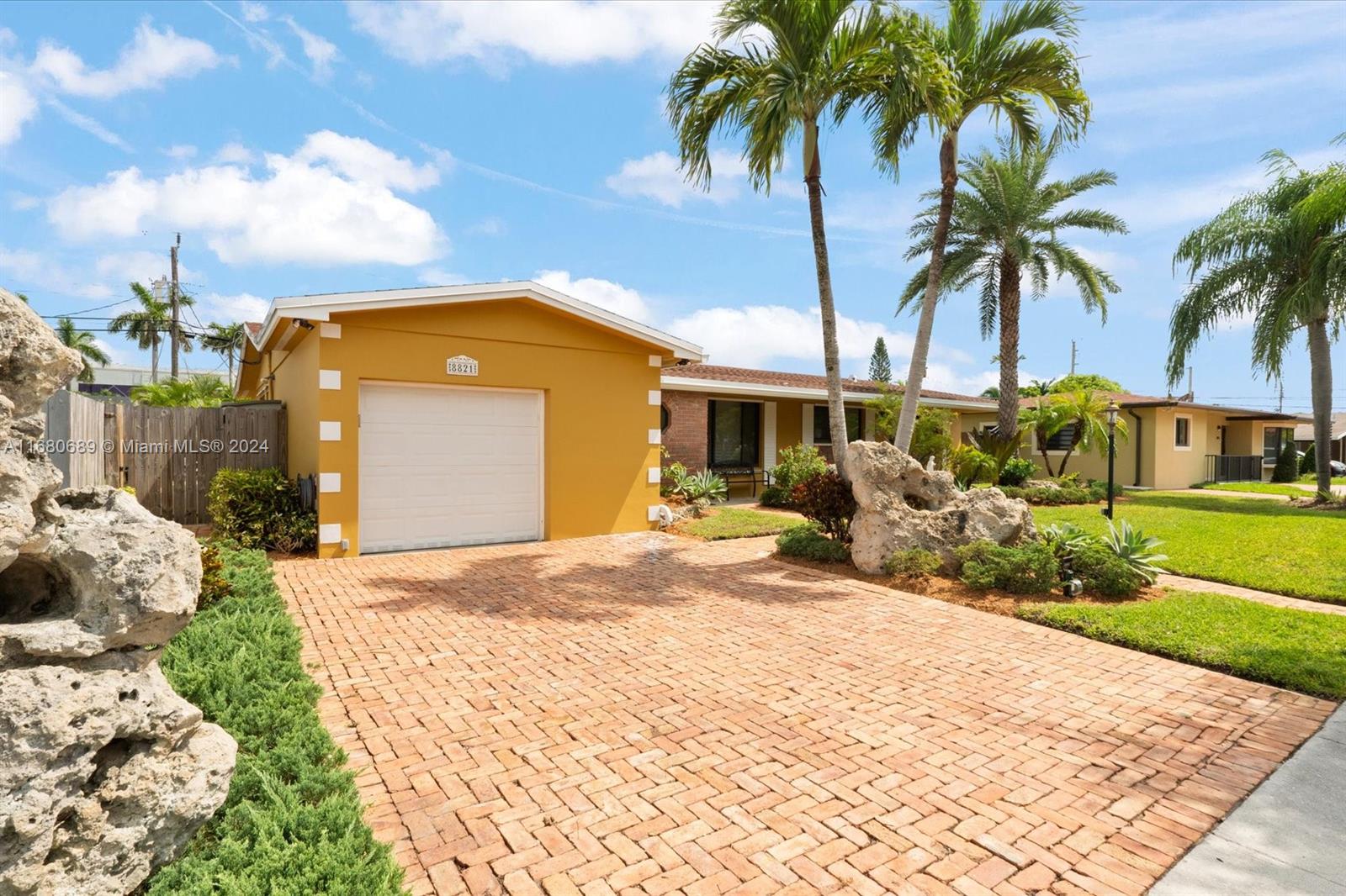 a front view of a house with garden and patio