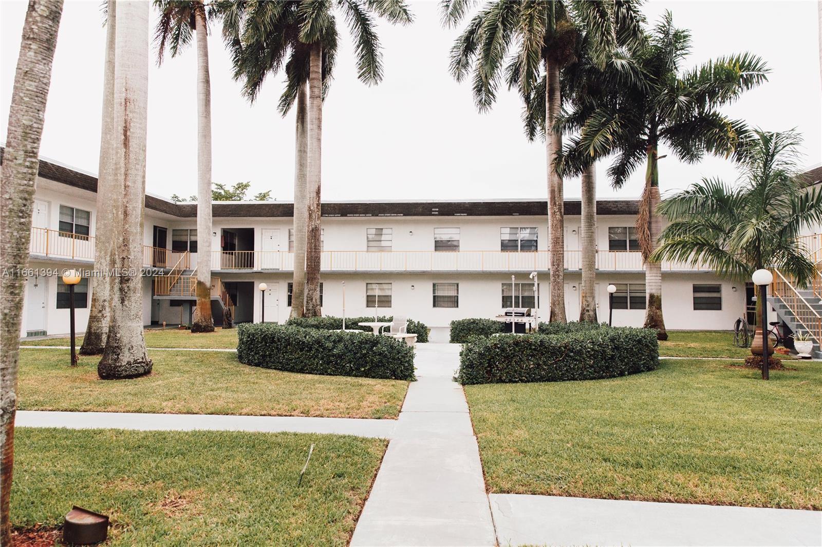 a front view of multiple houses with yard