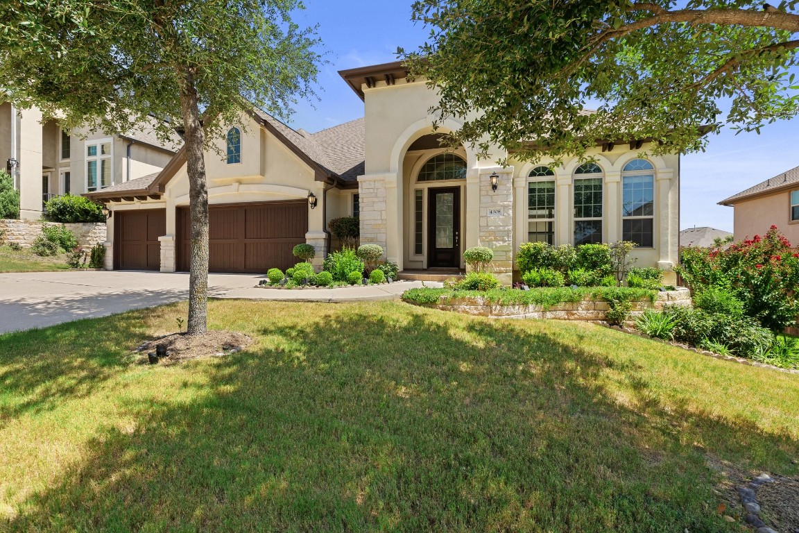 a front view of a house with a yard and garage