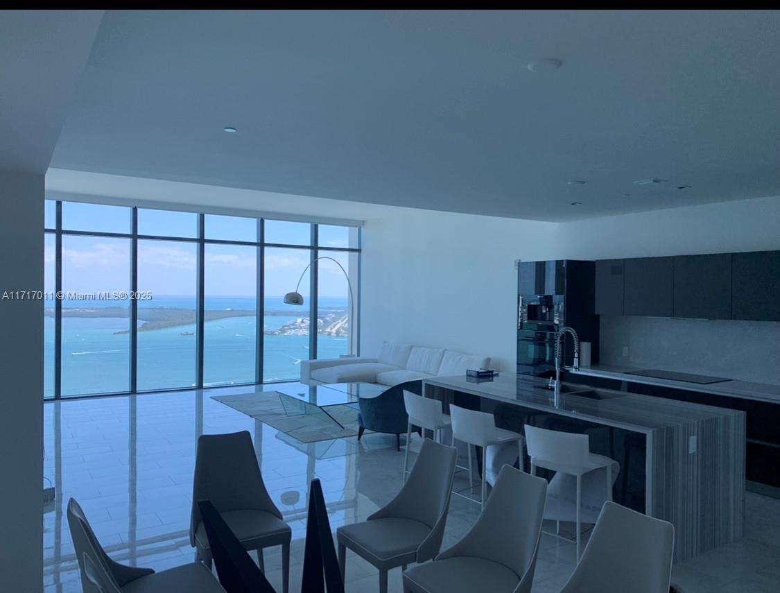 a view of a dining room with furniture and window