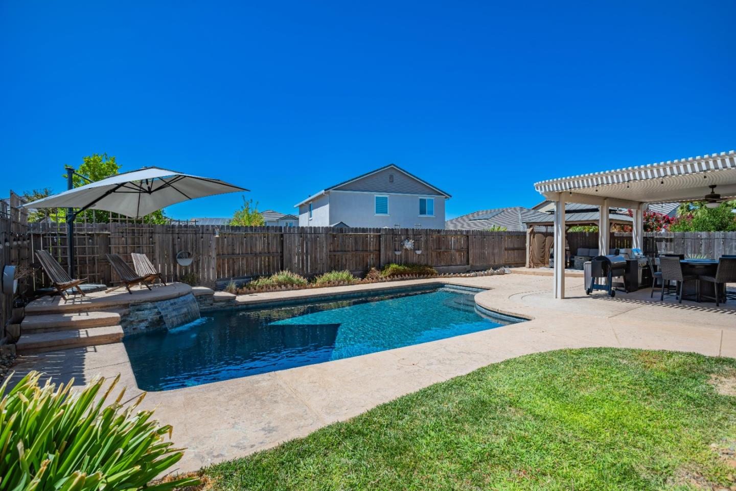 a view of a house with swimming pool and sitting area