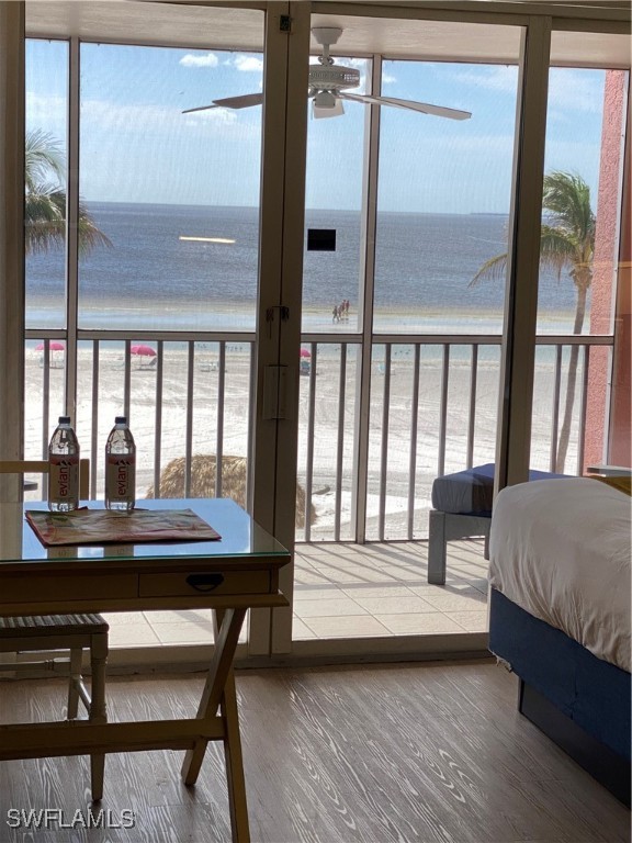 a bedroom with a bed and a large window with balcony view