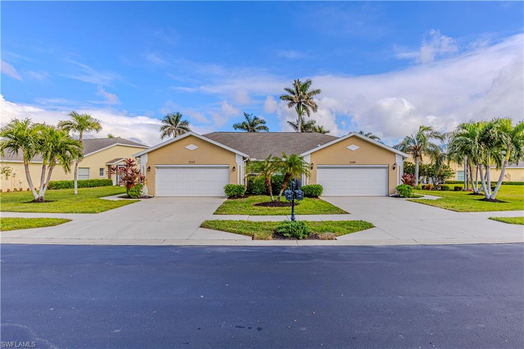 Single story home featuring a garage and a front lawn