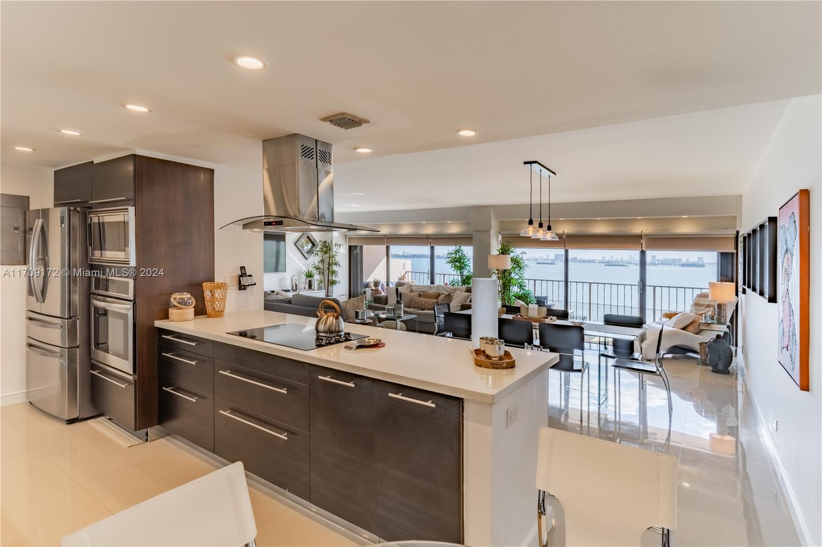 a kitchen with stainless steel appliances a sink a stove and a refrigerator