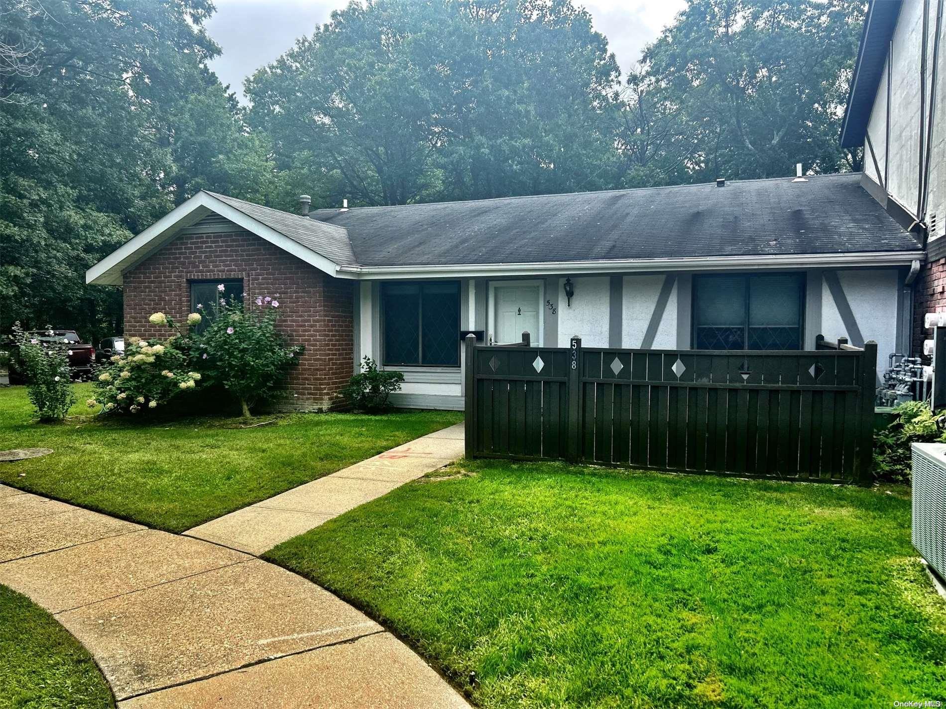 a view of a house with a yard and plants