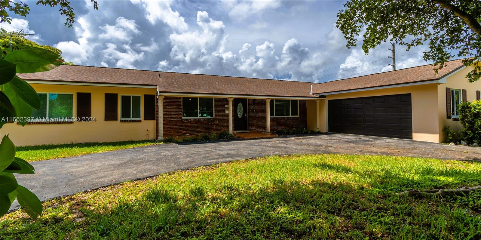 a view of house with yard and entertaining space