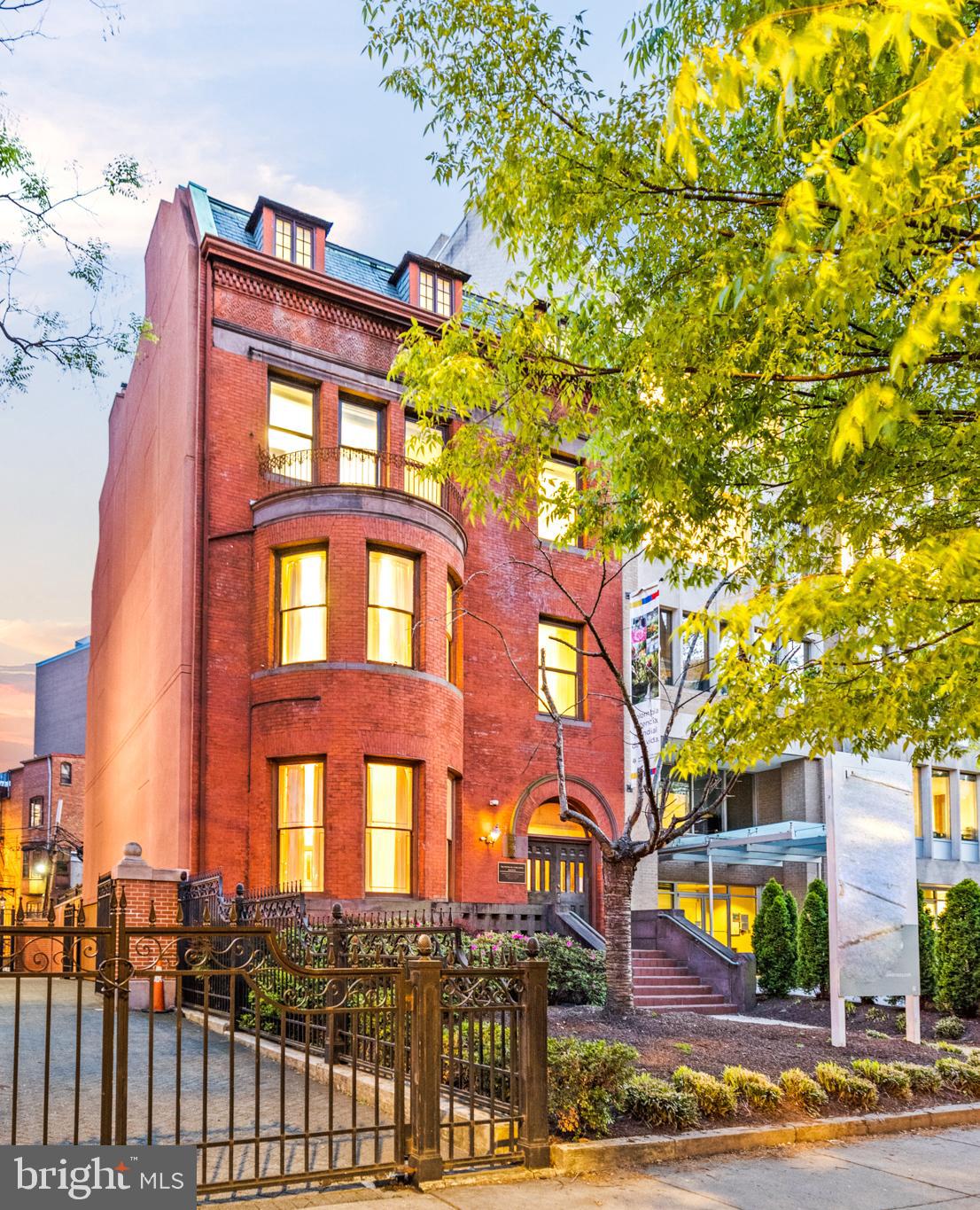 a front view of a residential apartment building with a yard