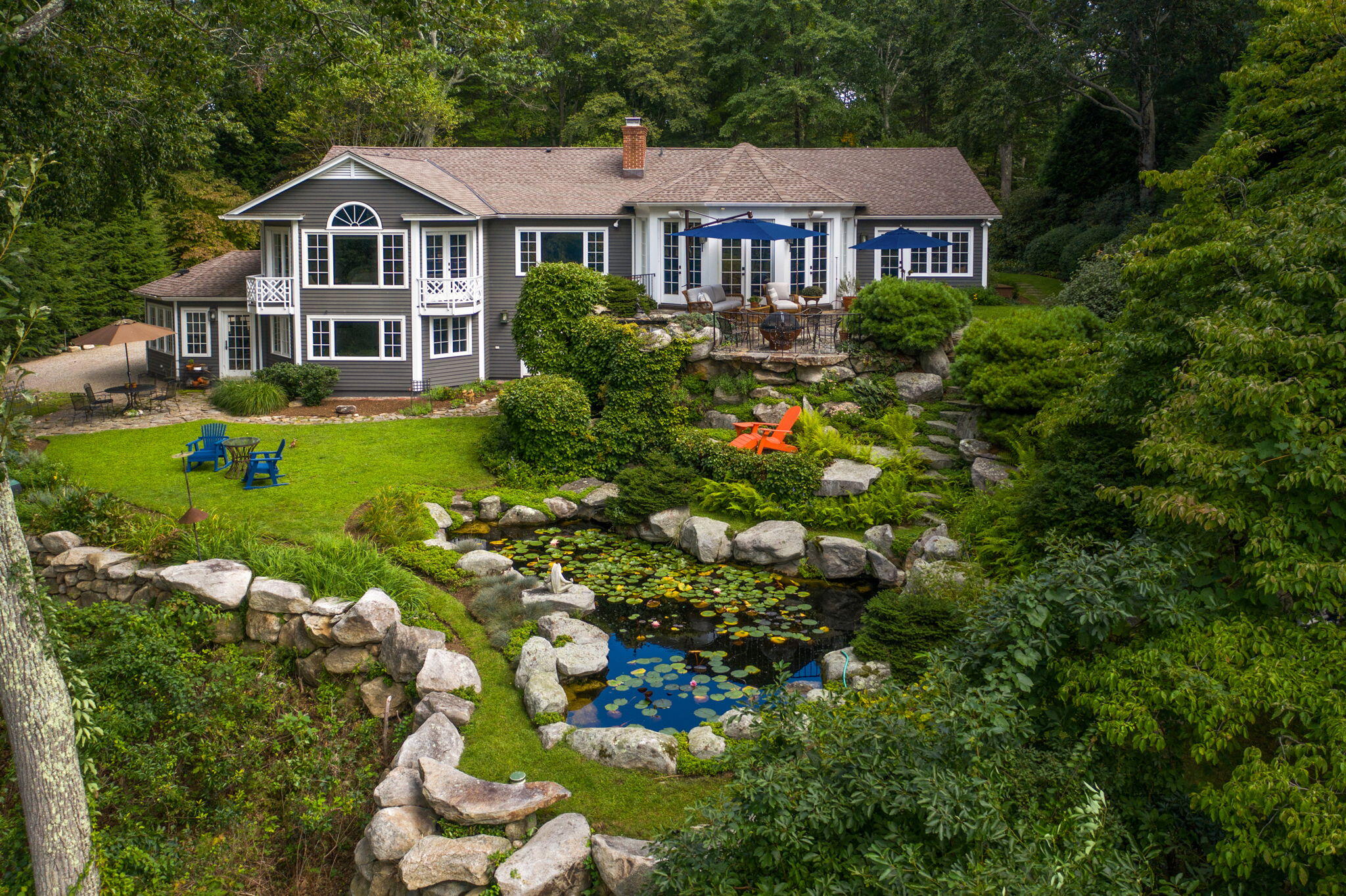 a front view of a house with a yard and potted plants