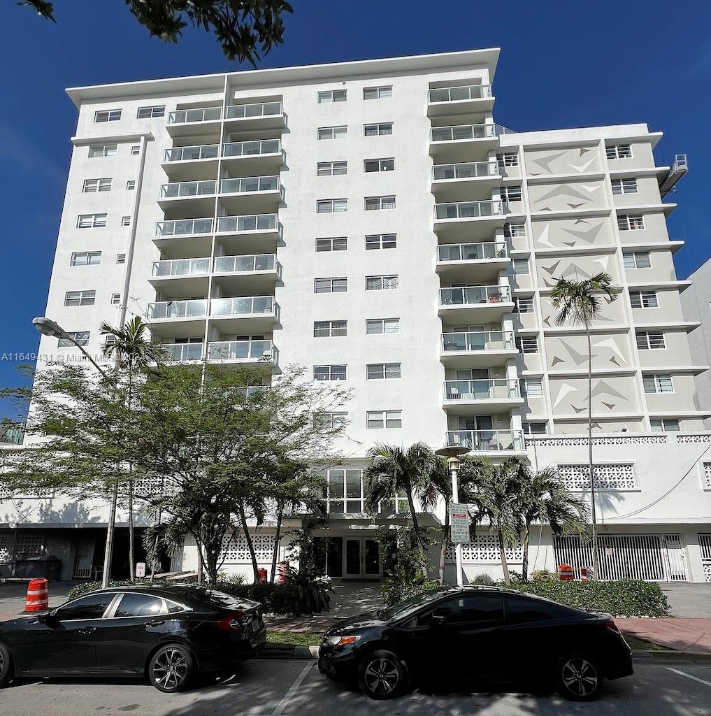 a front view of a building with parking space