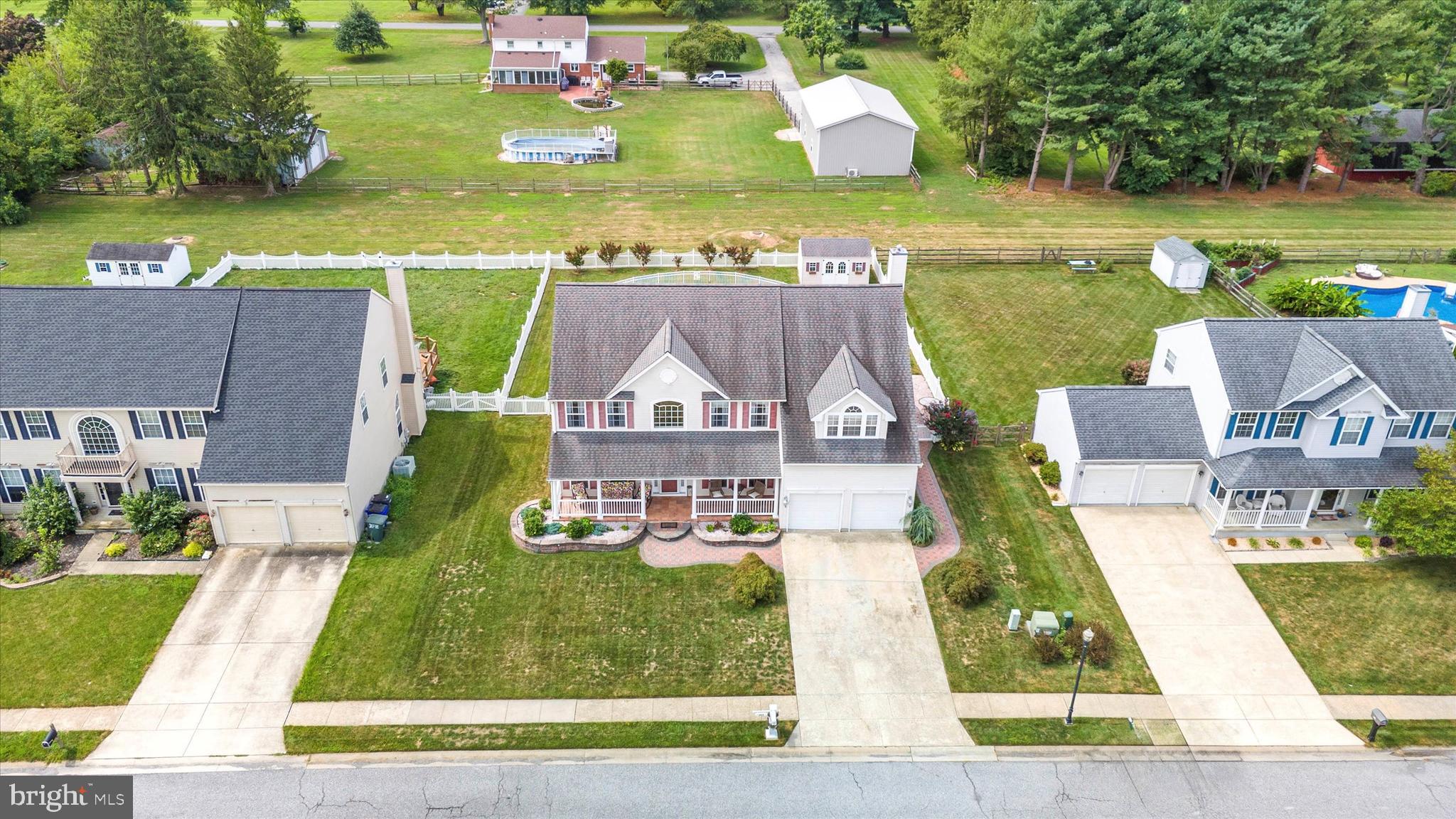 an aerial view of a house with a yard basket ball court and outdoor seating