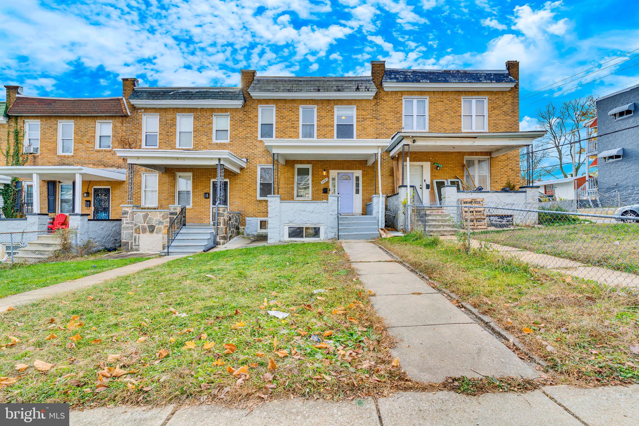 a front view of a residential apartment building with a yard