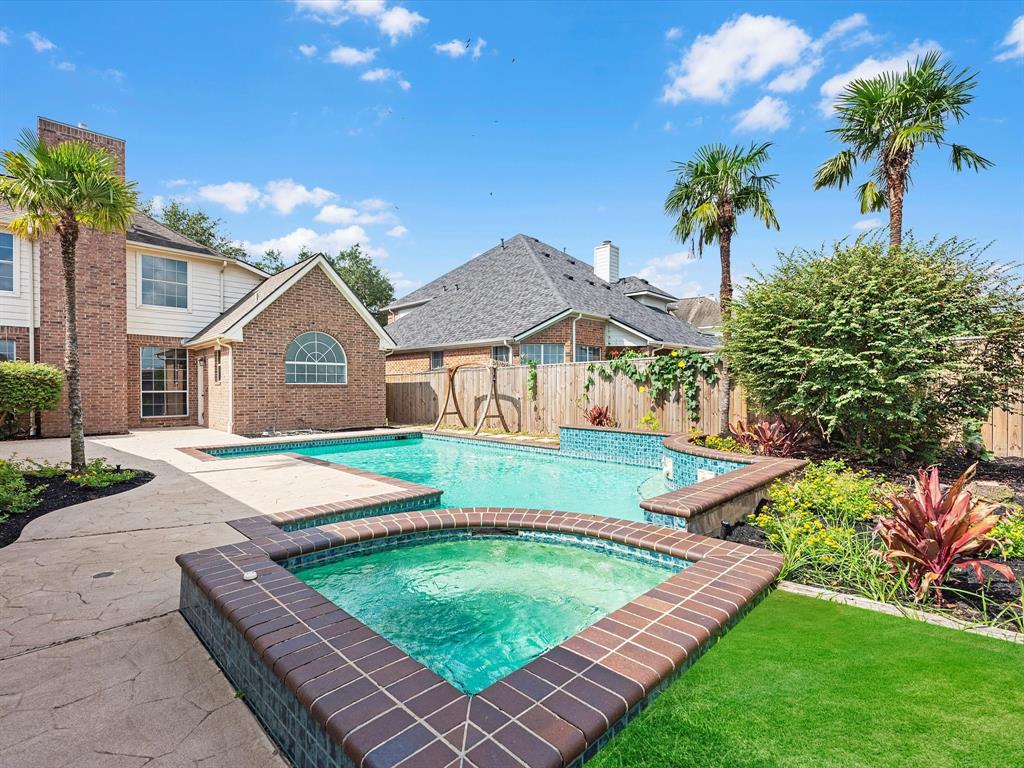 spa near outdoor kitchen and additional bath.