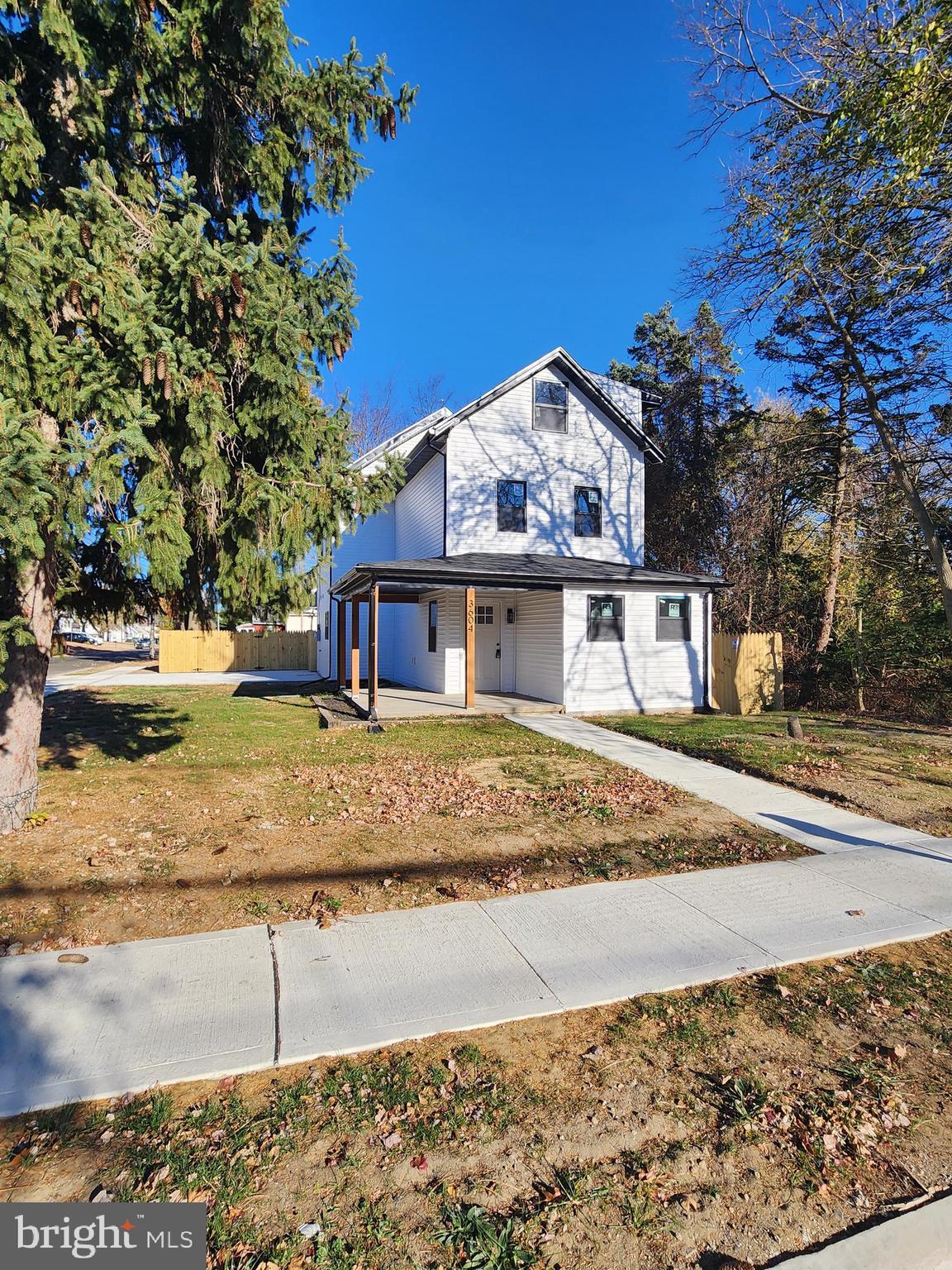 a view of a large house with a yard and large tree