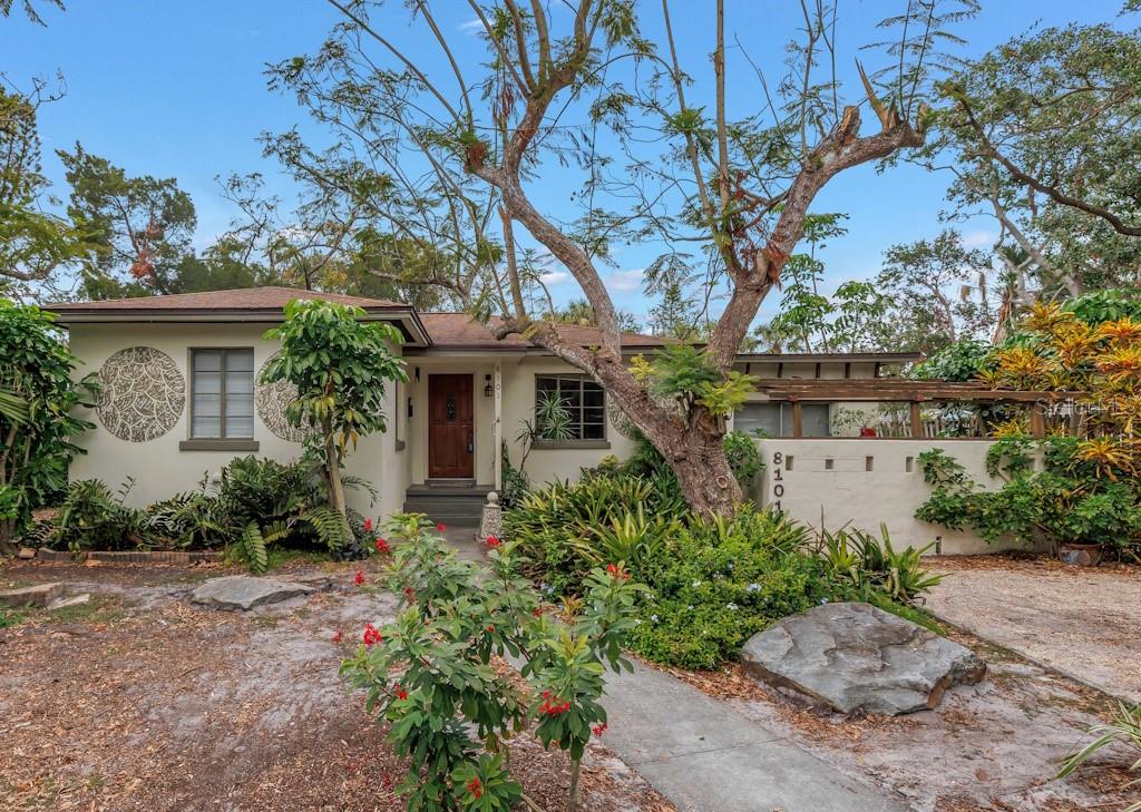 front view of a house with a tree