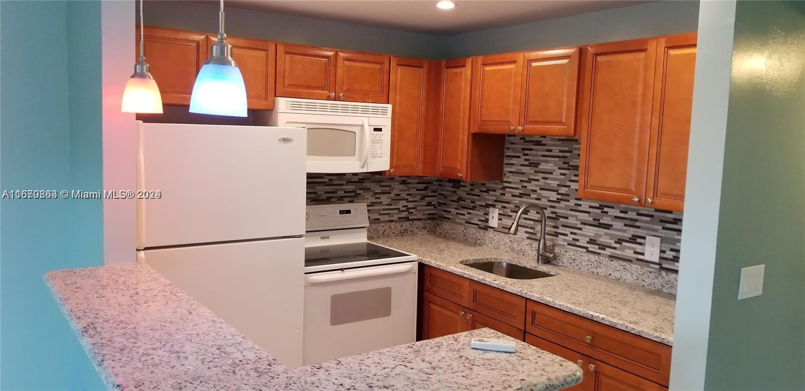 a kitchen with a sink and a refrigerator