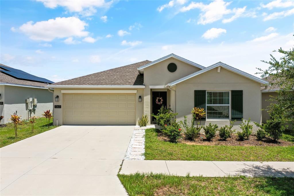 a front view of a house with a yard and garage