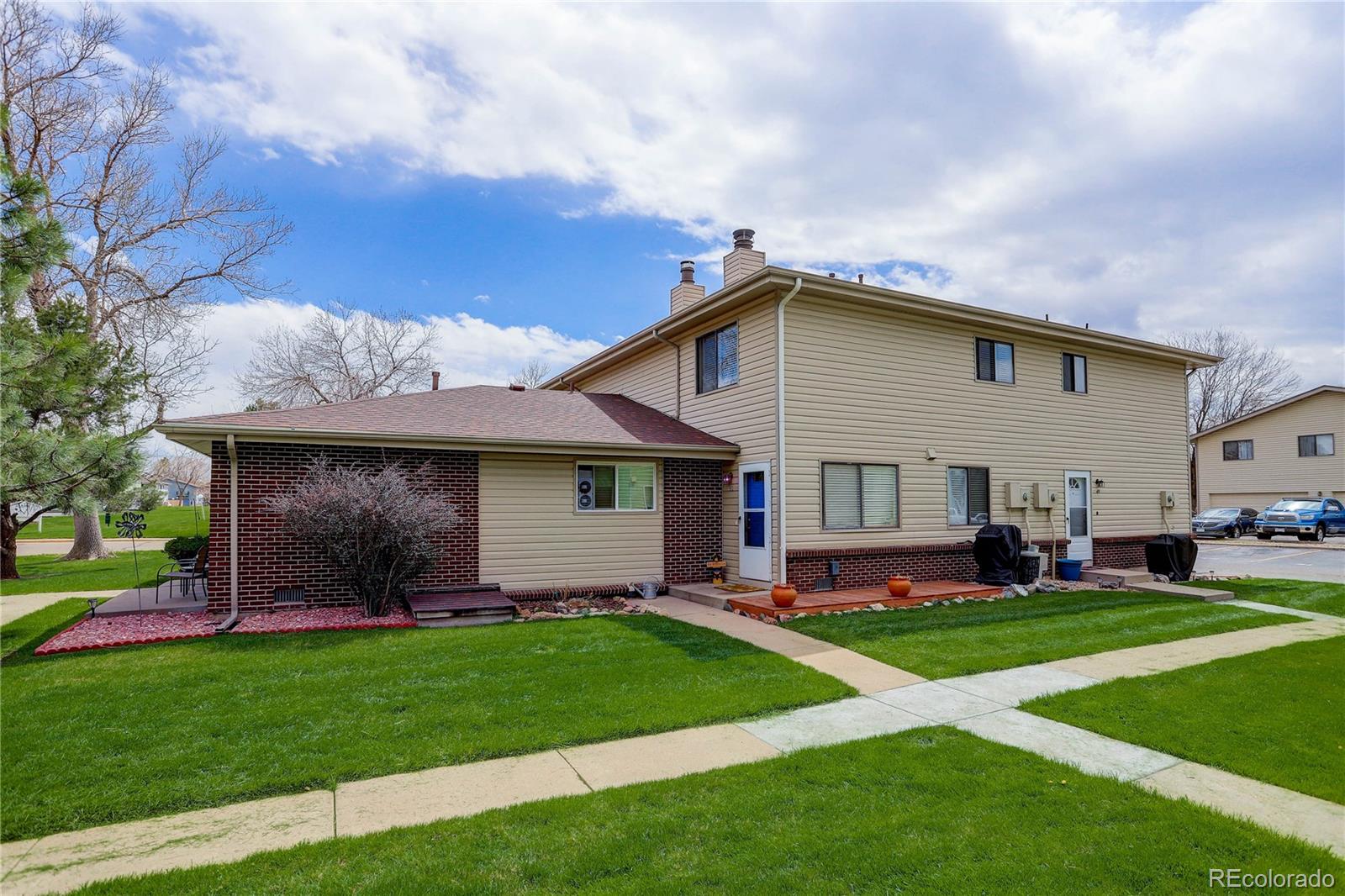 a front view of house with yard and green space