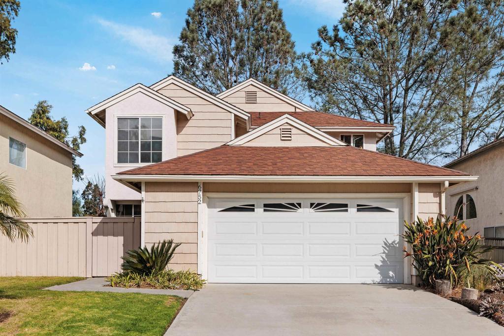 a front view of a house with a yard garage and outdoor seating