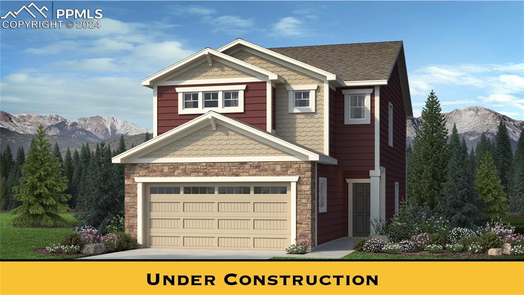 View of front facade with a garage and a mountain view