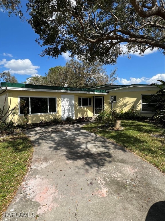 a front view of house with yard and green space