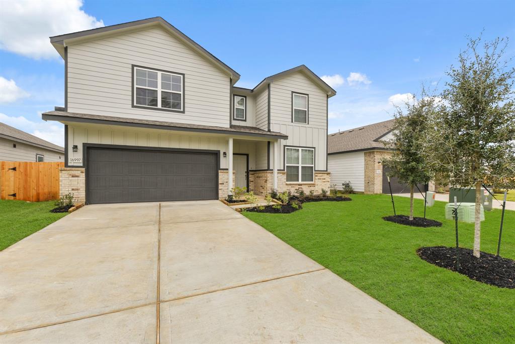 a front view of a house with a yard and garage