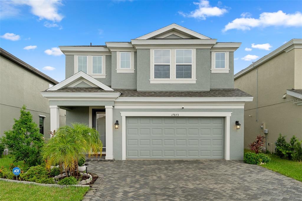 a front view of a house with a yard and garage