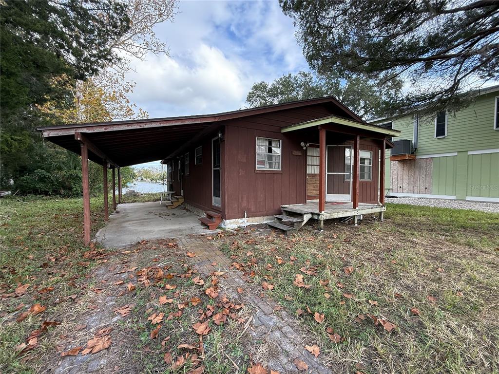 a view of a house with a yard and wooden fence