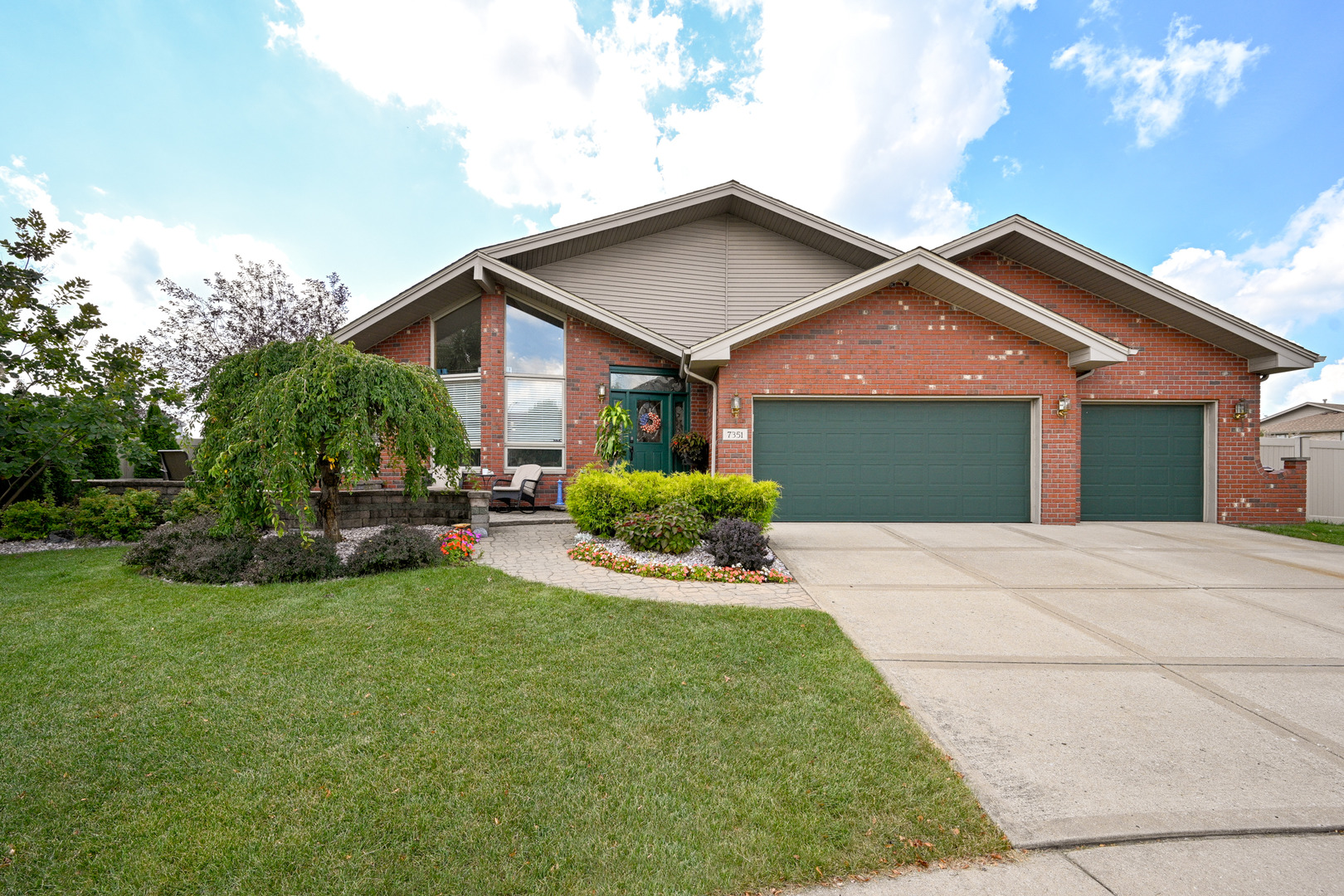 a front view of house with yard and green space