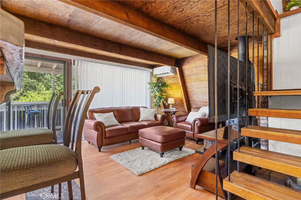 a living room with furniture a fireplace and large windows