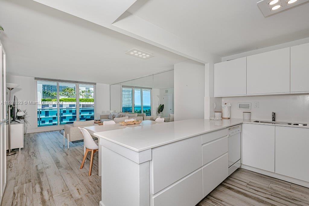 a kitchen with a sink window and cabinets