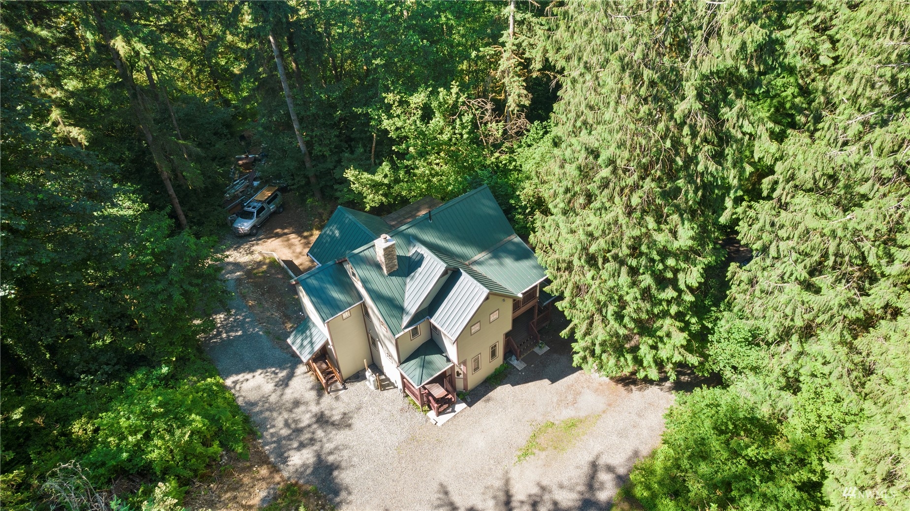 an aerial view of a house with outdoor space and sitting area