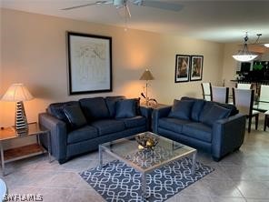 a living room with furniture a rug and a lamp