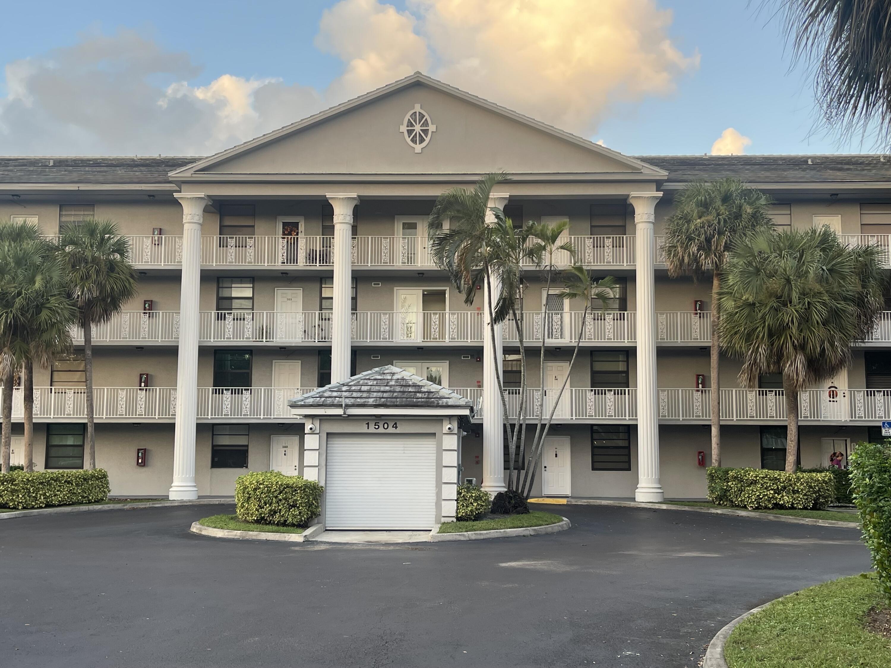 a front view of a building with a garden