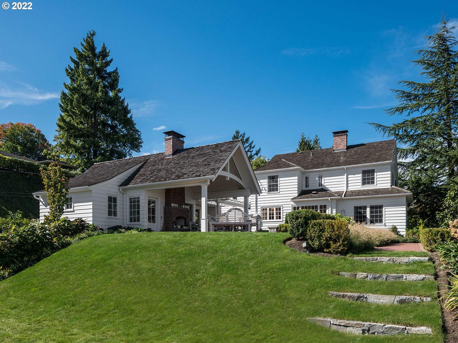 a front view of a house with a garden